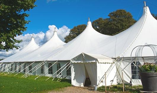 a row of portable toilets placed outdoors for attendees of a special event in Byfield